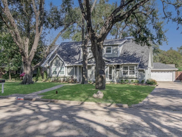 view of front of home with a front yard and a garage