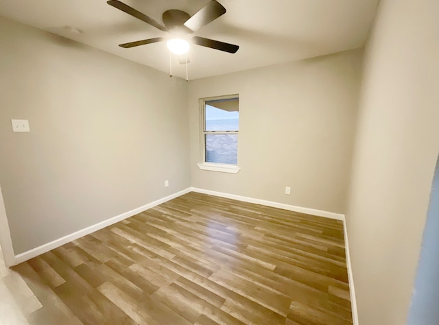 unfurnished room with hardwood / wood-style floors and ceiling fan