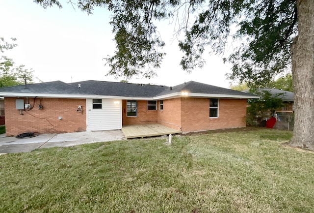 back of property with a patio area, a wooden deck, and a lawn