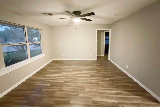 spare room featuring hardwood / wood-style floors and ceiling fan