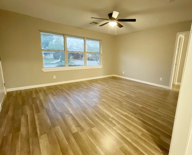 spare room featuring ceiling fan and wood-type flooring