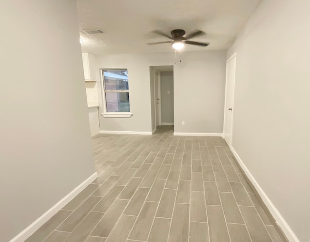 empty room featuring ceiling fan and wood-type flooring