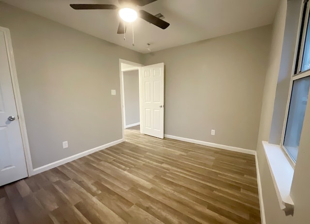 unfurnished bedroom featuring ceiling fan and hardwood / wood-style floors