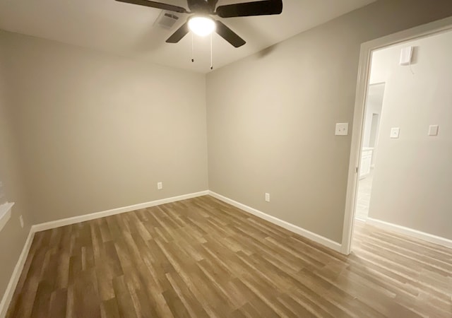 unfurnished room featuring hardwood / wood-style flooring and ceiling fan