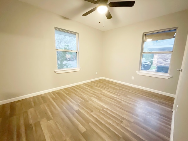 spare room featuring light wood-type flooring and ceiling fan