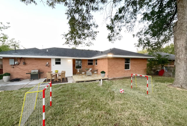 back of house with a wooden deck and a lawn