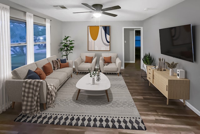 living room featuring ceiling fan and dark hardwood / wood-style floors