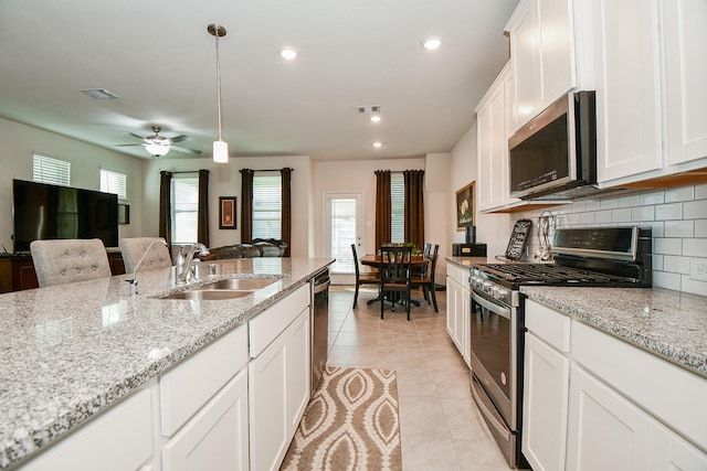 kitchen with visible vents, appliances with stainless steel finishes, a sink, and light tile patterned flooring