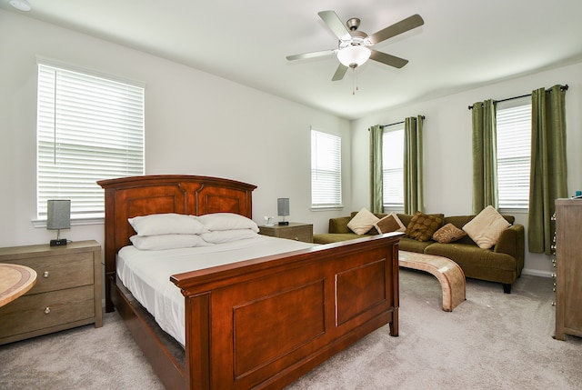 carpeted bedroom with multiple windows and ceiling fan