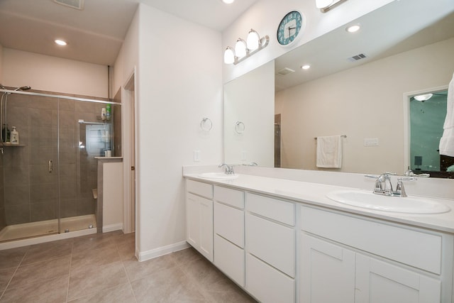 full bathroom with a stall shower, tile patterned flooring, visible vents, and a sink