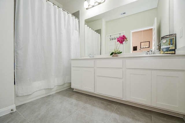 full bath with double vanity, tile patterned flooring, visible vents, and a sink