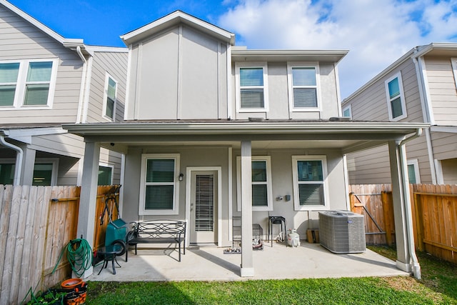 rear view of house with a patio area and central air condition unit