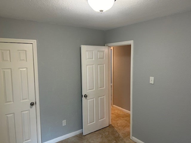 unfurnished bedroom with a textured ceiling