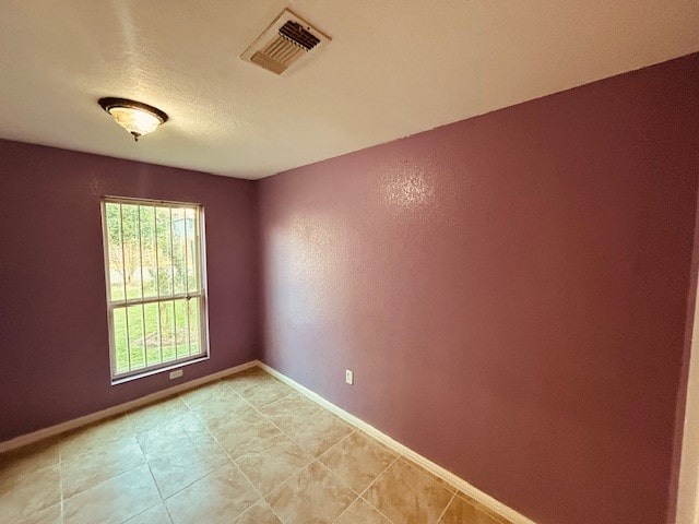 empty room with light tile patterned floors