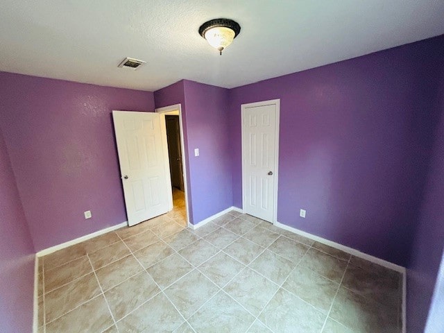 unfurnished bedroom featuring light tile patterned flooring