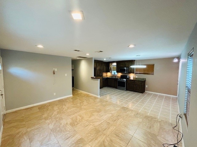 kitchen with appliances with stainless steel finishes and dark brown cabinets