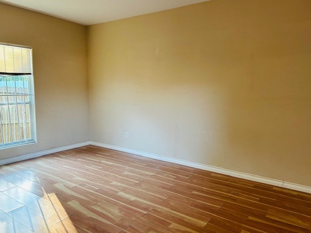 unfurnished room with light hardwood / wood-style floors