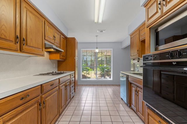 kitchen featuring appliances with stainless steel finishes, pendant lighting, and light tile patterned flooring