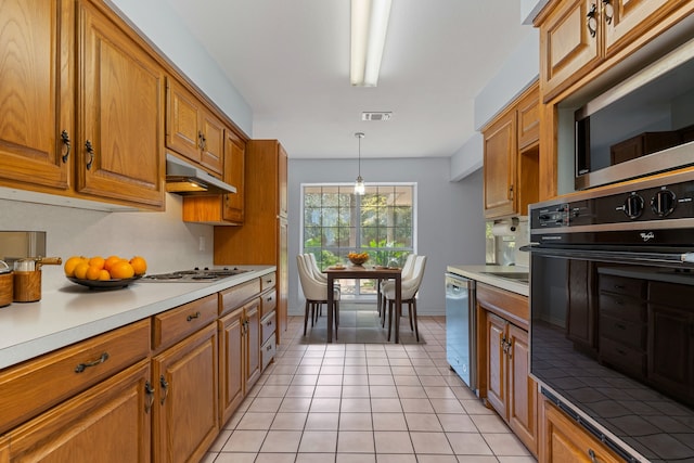 kitchen with stainless steel appliances, hanging light fixtures, and light tile patterned floors