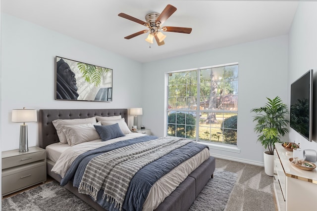 bedroom with ceiling fan and light colored carpet