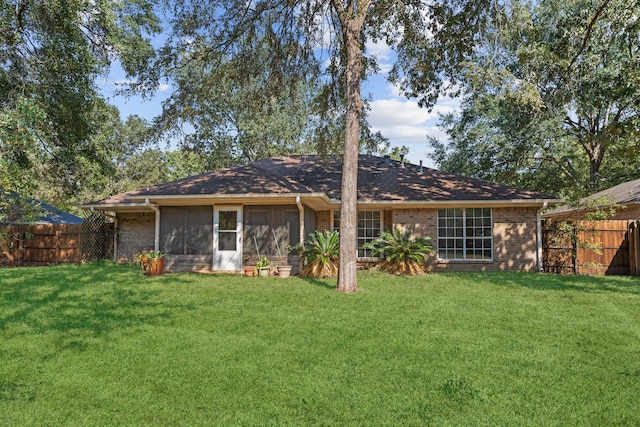 back of house featuring a lawn