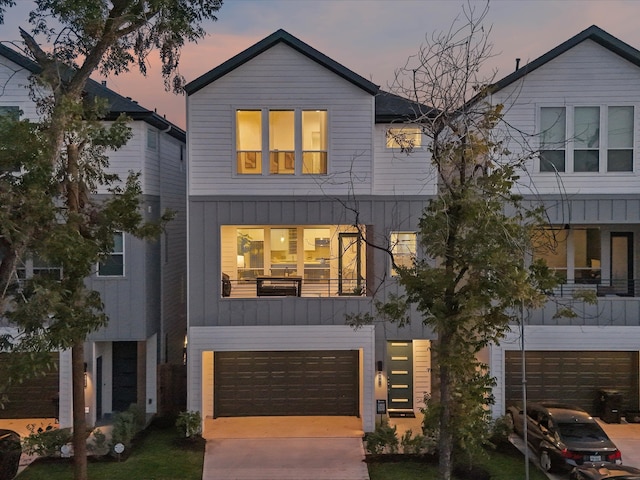 view of front of property featuring a balcony and a garage