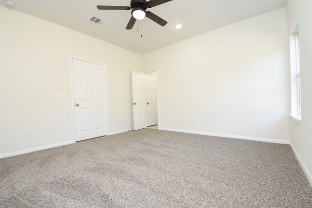 carpeted empty room featuring ceiling fan