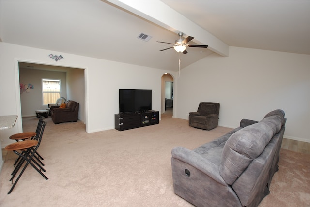 carpeted living room featuring vaulted ceiling with beams and ceiling fan