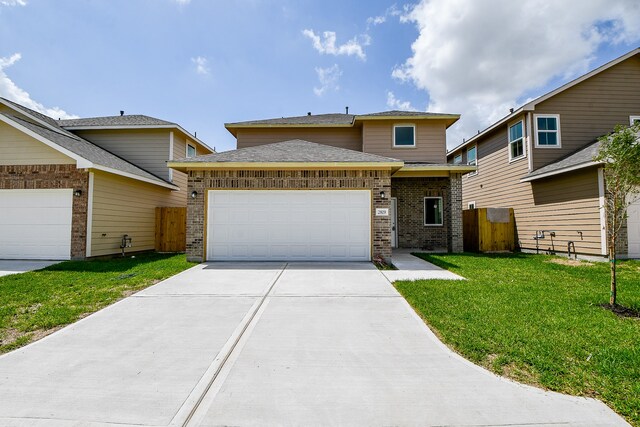 view of front of house with a front yard and a garage