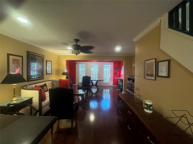 living room with crown molding, ceiling fan, and dark wood-type flooring