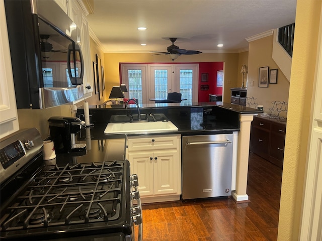 kitchen with white cabinets, sink, stainless steel appliances, dark hardwood / wood-style floors, and crown molding