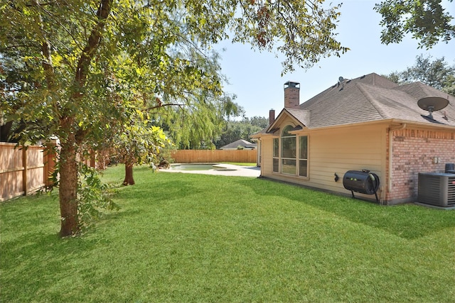 view of yard featuring cooling unit and a patio