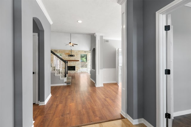 12546 Castlestone Dr, Houston, TX 77065 - hallway featuring arched walkways, stairs, wood finished floors, and visible vents