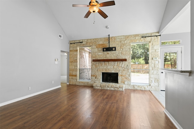 unfurnished living room featuring a fireplace, wood-type flooring, high vaulted ceiling, and ceiling fan