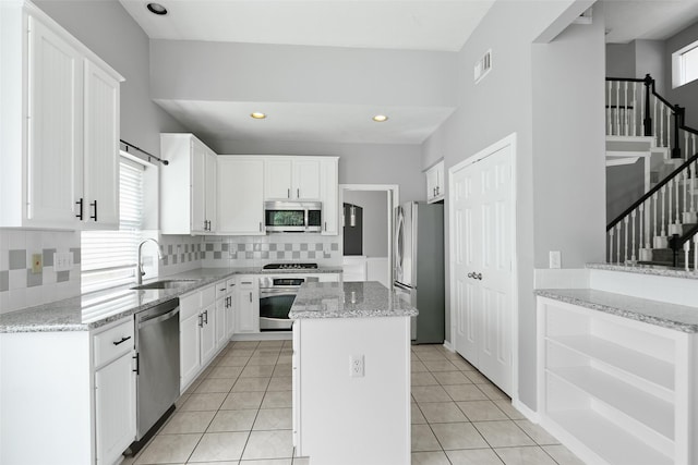12546 Castlestone Dr, Houston, TX 77065 - kitchen featuring backsplash, visible vents, appliances with stainless steel finishes, a sink, and white cabinetry