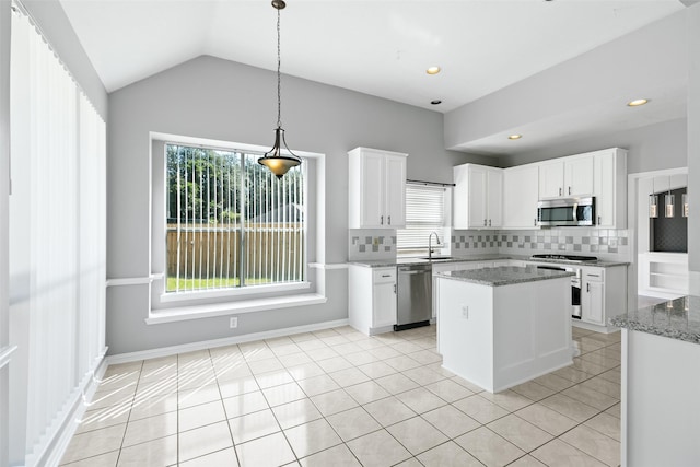 12546 Castlestone Dr, Houston, TX 77065 - kitchen with light tile patterned flooring, white cabinetry, tasteful backsplash, light stone counters, and appliances with stainless steel finishes