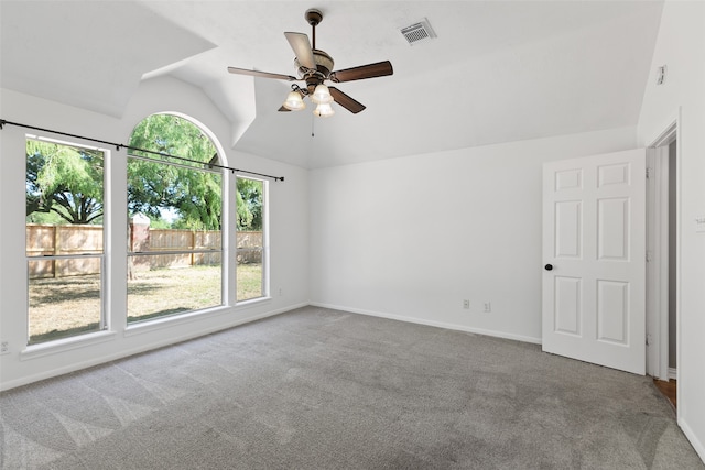 carpeted spare room featuring ceiling fan and vaulted ceiling