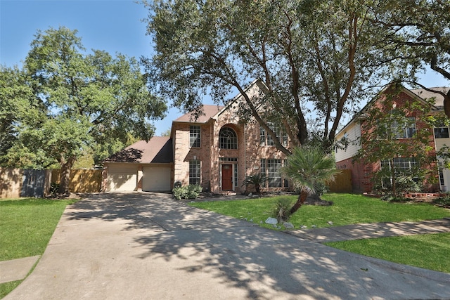 12546 Castlestone Dr, Houston, TX 77065 - traditional-style home featuring fence, a front yard, brick siding, an attached garage, and driveway
