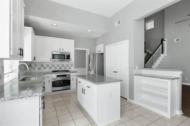 12546 Castlestone Dr, Houston, TX 77065 - kitchen featuring visible vents, open shelves, tasteful backsplash, a sink, and stainless steel appliances