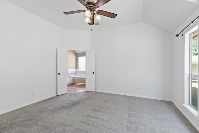 spare room with light carpet, ceiling fan, and lofted ceiling