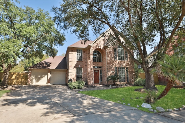 view of front of home featuring a front yard and a garage