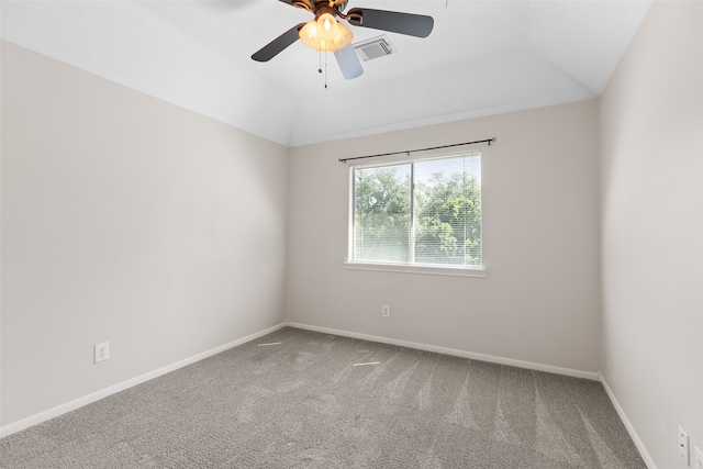 carpeted spare room featuring a raised ceiling, ceiling fan, and lofted ceiling