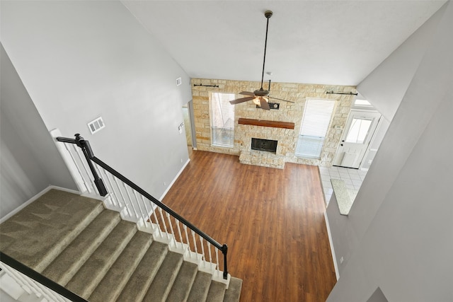 12546 Castlestone Dr, Houston, TX 77065 - unfurnished living room with visible vents, wood finished floors, a fireplace, baseboards, and a ceiling fan