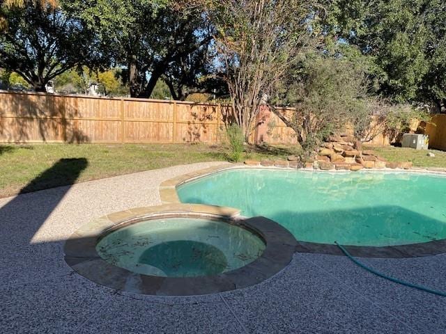 view of pool with a patio area and an in ground hot tub