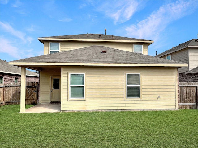 rear view of house featuring a patio area and a lawn