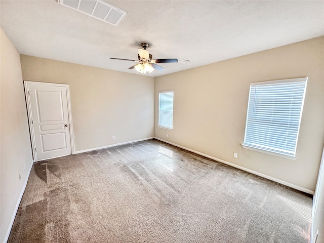 unfurnished room with ceiling fan and carpet floors