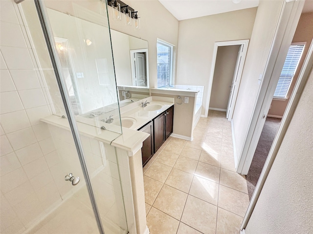 bathroom featuring vanity, a shower with shower door, and tile patterned flooring