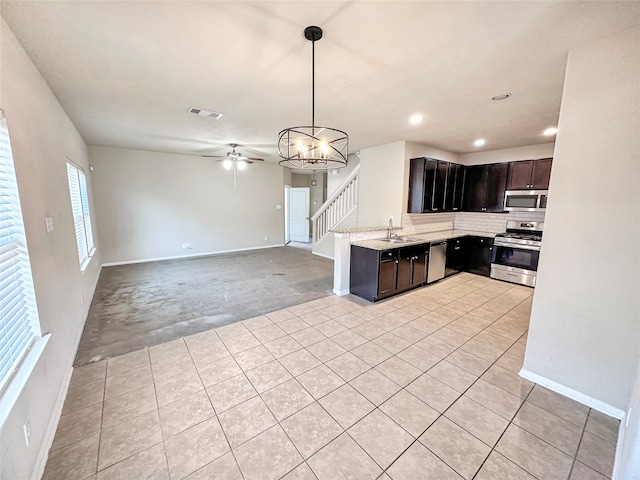 kitchen featuring appliances with stainless steel finishes, sink, hanging light fixtures, and a wealth of natural light