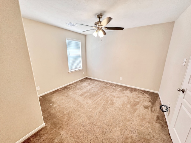 carpeted empty room featuring ceiling fan