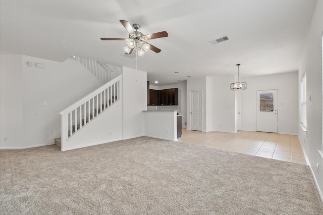 10 Garden Ridge Ct, Manvel, TX 77578 - unfurnished living room featuring light colored carpet, stairs, light tile patterned flooring, a ceiling fan, and baseboards